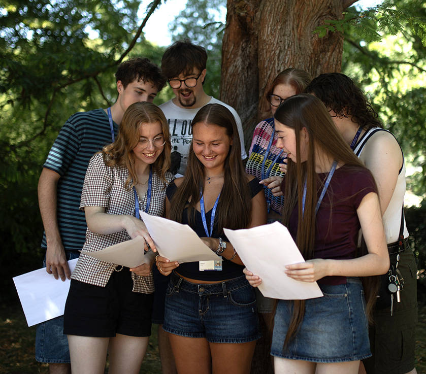 Students reviewing event materials together outdoors
